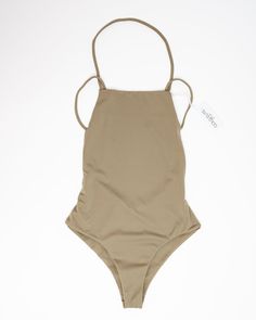 Our Mia one piece is the perfect addition to your beach wardrobe! Featuring a low drop back and side detailing, plus a high leg and solid color design, you'll be sure to turn heads all summer long. Make a splash in this plus-size one-piece from our size-inclusive swimwear collection. Gold Elite Mia One Piece | Olive | Swimsuits | Materials & Care Instructions: ['80% Nylon, 20% Spandex', 'Imported'] Solid Color Beachwear Swimwear For Beach Season, Solid Backless Bodysuit For Vacation, Summer Beachwear Swimwear In Solid Color, Solid Color Backless Bodysuit For Vacation, Solid Color Summer Beachwear Swimwear, Summer Solid Color Swimwear, Solid Color Beachwear For Summer, Backless One Piece Swimsuit For Poolside Summer, Summer Backless One-piece Swimsuit With Lined Body