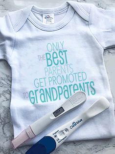 an electronic thermometer sitting next to a baby's t - shirt that says, only the best parents get promote grandparents