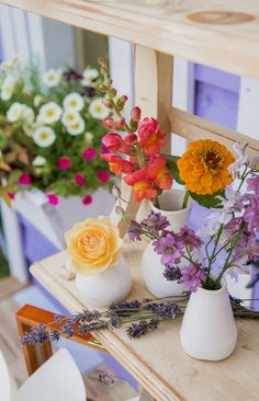 various flowers in vases sitting on a table