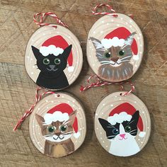 four ornaments with cats wearing santa hats on them