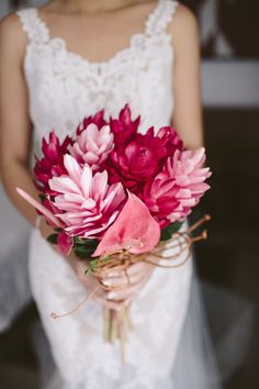 a bride holding a bouquet of flowers in her hand and the caption says, buta bridal wedding blog / digby