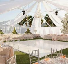 an outdoor wedding reception setup with tables and chairs