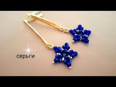 a pair of blue beaded earrings on top of a table