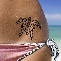 a woman's back with a tattoo on the side of her body and an image of a turtle