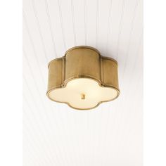 a ceiling light that is hanging from the ceiling in a room with white walls and wood paneling