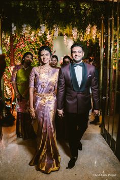 a man and woman walking down a hall