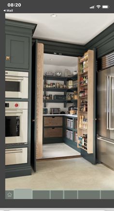 an open pantry in the middle of a kitchen with lots of cupboards and drawers