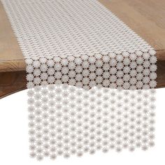 the table is covered with white doily and has brown dots on it's edge