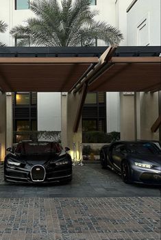 two bugatti cars parked in front of a hotel