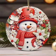 a snowman ornament hanging from a christmas tree