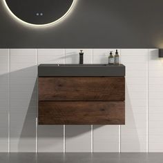 a bathroom with a sink, mirror and lights on the wall next to each other