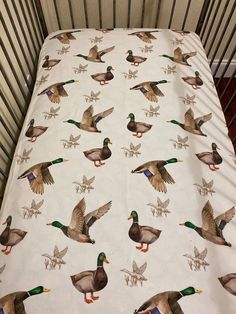 a crib bed with ducks on it