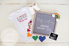 a baby's first birthday gift with personalized onesuits and other items