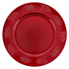 a red plate with pine cones and leaves on it