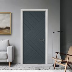 a living room with grey walls and white rugs on the floor next to a gray door