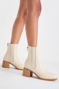 All your favorite fall 'fits are definitely going to include the Karlach Light Nude Low Heel Ankle Booties! Faux pebbled leather shapes these essential autumn boots that feature an almond-shaped toe upper and a 6.25"" ankle-high shaft with a 5.5"" zipper at the back and elastic gussets on either side. A stacked block heel completes the trendy look! 2. 5" stacked wood-look block heel. Lightly cushioned insole. Nonskid rubber sole. Man made materials. Imported. Lulus | Karlach Light Nude Low Heel Beige Booties No Heel, Cream Block Heel Booties For Spring, Chic Beige Low Heel Booties, Cream High Ankle Booties Medium Width, Spring Leather Booties With 4-inch Heel, Autumn Boots, Gift Wishlist, Almond Shaped, Boots Fall