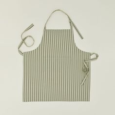 an apron with two ties hanging from it's side, and one has a striped design on the front