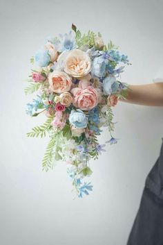 Cascading bridal bouquet in pink, peach, and blue Bridgerton Flower Bouquet, Pink Peonies And Blue Hydrangeas, Pastel Colorful Bouquet, Pastels Wedding Bouquet, Wedding Colors For Spring 2024, Xv Flower Centerpieces, Bridgerton Pastel Wedding Theme, Low Spring Centerpieces, Wedding Flowers With Blue Dresses