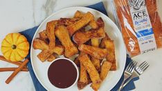 a white plate topped with french fries and dipping sauce