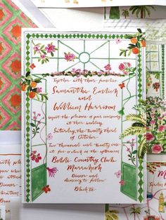 the wedding stationery is decorated with flowers and greenery