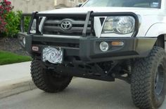 the front end of a white toyota truck