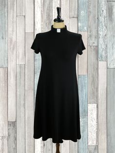 This fashionable, extremely comfortable dress flatters every body type. Customers have described this as wearing pajamas! Best of all, it comes with pockets! Click for information on: Sizing Collar Fabric Length Black Knee-length Dress With Invisible Zipper, Black Rayon Knee-length Dress, Black Knee-length Midi Dress With Gathered Sleeves, Black Relaxed Fit T-shirt Dress With Crew Neck, Mesh Sleeves, Comfortable Dress, Swing Dress, Body Types, High Neck Dress