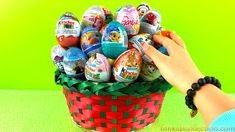 a person is holding an easter basket full of decorated eggs on a green background with the words happy easter written in it