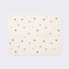 a white tray with multicolored dots on it