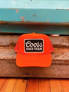 Classic trucker hat for the Coors Race Team Adjustable snap back One size fits most Curved, moldable bill Orange Trucker Snapback Hat, Orange 5-panel Adjustable Trucker Hat, Orange Trucker Baseball Cap One Size, Casual Orange 5-panel Trucker Hat, Orange Trucker Hat With Curved Brim, Orange Trucker Hat One Size, Adjustable Orange Trucker Hat With Flat Bill, Orange Trucker Hat, One Size Fits Most, Orange Adjustable Trucker Hat With Curved Bill