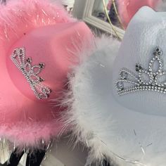 two hats with tiaras on them sitting next to each other