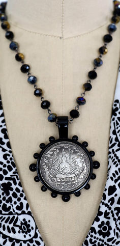 Spiritual Black Coin Pendant Jewelry, Black Spiritual Jewelry With Coin Pendant, Black Amulet Necklace With Coin Pendant, Collectible Spiritual Coin Necklaces, Handmade Coin-shaped Spiritual Jewelry, Black Spiritual Necklace With Coin Pendant, Spiritual Antique Silver Coin Pendant Jewelry, Vintage Medallion Coin Necklace With Large Pendant, Vintage Coin Shaped Jewelry With Large Pendant