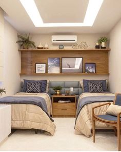 two beds sitting next to each other in a room with wooden shelves above the beds