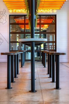 the inside of a restaurant with tables and benches in front of an orange sign that says pinnacle avenue