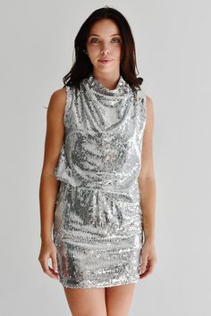 If you're looking for a little silver sequin party dress with a twist, meet our Rockstar dress! This silver sequin mini features a draped mock neck and muscle style top. Hits mid-thigh. Zipper back. This flirty sequin mini brings you timeless style year after year. FIT: Runs slim. We recommend sizing up. MATERIAL: Self: 100% Polyester. Lining: 100% Polyester. SIZE GUIDE: S (0-2) / M (4-6) / L (8-10) CARE: Dry clean only. MODEL DETAILS: Our model Karlie (photos) is 5'7 and wearing a size S. Karlie's measurements - Bust: 32B, Waist: 25.5", Hips: 35.5". Rockstar Dress, Silver Sequin Mini Dress, Sequin Party, Top Hits, Sequin Party Dress, Sequin Mini, Silver Sequin, Sequin Mini Dress, Timeless Style