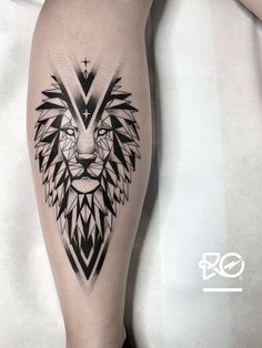 a black and white lion tattoo on the right leg, with geometric shapes around it