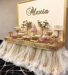 a table topped with lots of desserts next to a sign that says alexia