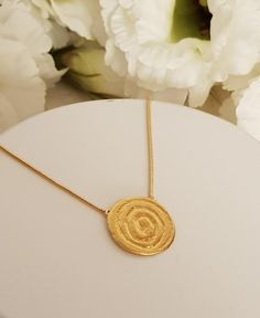 18K gold plated tribal spiral pendant necklaceThis simple design is perfect for every day, layered or worn alone.Lovely as a bridesmaids gift or as wedding jewelry! Each necklace will arrive in a black gift box. Spring clasp closure on 2 mm chainPendant Height: 20 mmPendant Width: 18 mmThe gold plating is a high quality 3 microns 18k gold thickWeight: 5 GramModel is shown with 17-inch chainSelect chain length at checkoutThis Necklace has Matching earrings: https://etsy.me/2V4iYHHSKU TP0147Custom 22k Gold Round Pendant Necklace For Wedding, Gold Spiral Necklace For Gifts, Gold Spiral Necklace For Gift, Gold Spiral Necklace As A Gift, Spiral Yellow Gold Necklace For Gift, Spiral Gold-plated Jewelry, Handmade 22k Gold Round Necklaces, Wedding Pendant Necklace With Hammered Detail, Spiral Brass Necklace For Gift