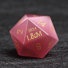 a red dice with gold numbers on it