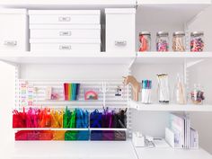 a white shelf filled with lots of craft supplies