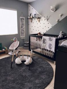 a baby's room with grey walls and black carpeted flooring is decorated in an animal theme