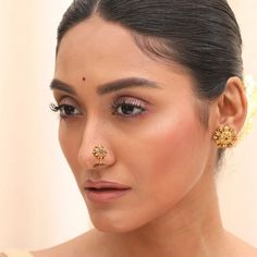 Description This elegant nose pin from Tarinika- antique collection features a floral motif inspired by the traditional Indian patterns. It has semi-precious stones on an antique gold base that add a touch of sparkle. This nose pin can complement any ethnic or fusion outfit, especially solid colors. Wear it with your favorite saree or kurta for a stunning look. Details & Specifications: Materials used: Brass Alloy with Oxidized Silver Plating Weight - Nose Pin-.1.85 gm Length - Nose Pin-1.5 cm M Gold Nose Studs For Wedding, Kundan Temple Jewelry Nose Rings For Festive Occasions, Festive Kundan Temple Jewelry Nose Rings, Elegant Nose Studs For Weddings, Temple Jewelry Style Nose Rings For Festivals, Elegant Nose Rings For Festivals, Gold Nose Rings For Puja And Festive Occasions, Gold Kundan Nose Rings Temple Jewelry, Gold Kundan Nose Ring In Temple Jewelry Style