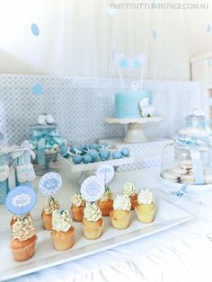 a table topped with lots of desserts and cupcakes