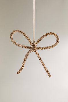 an ornament hanging from a string with a bow on it's end