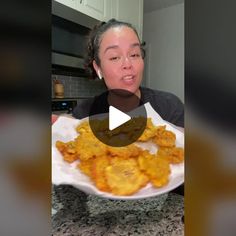 a woman holding a plate of food in front of her face and making a funny face