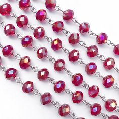 red glass beads with silver chain on white background