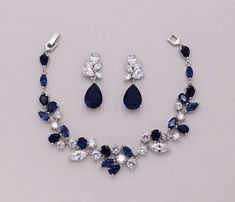 a necklace and earring set with blue stones