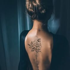 a woman with a flower tattoo on her back