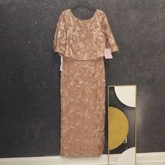 a woman's dress hanging on a wall next to a mirror