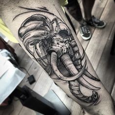 an elephant with some sort of design on it's arm and leg, in black and white