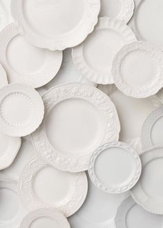 many white plates stacked on top of each other with the words, we are looking up